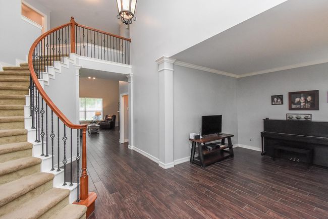 Back to your entryway, let's check out the right side of your first floor! Note the wrought iron spindle that adorn the staircase. Exciting news: Seller is offering $5K credit to replace the carpet to what you desire for the home. | Image 17