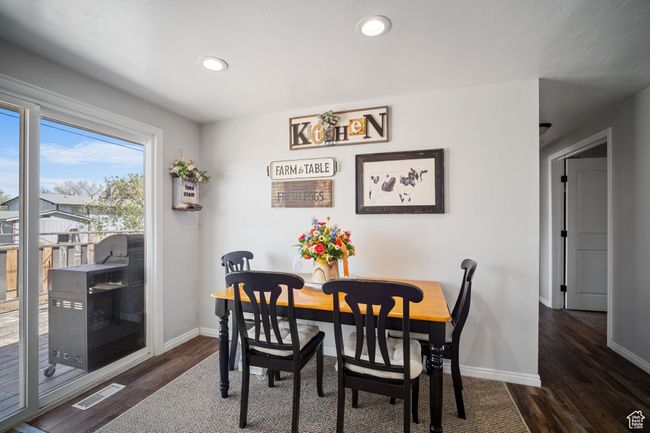 Dining space featuring dark wood-style floors, recessed lighting, visible vents, and baseboards | Image 7