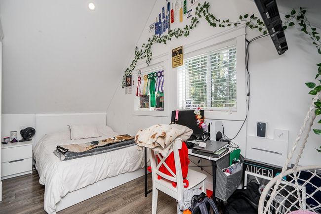 Bedroom with wood finished floors and vaulted ceiling | Image 23