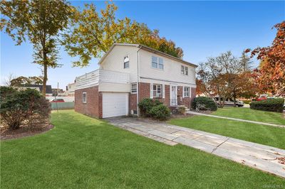 View of front of home with a front yard and a garage | Image 2