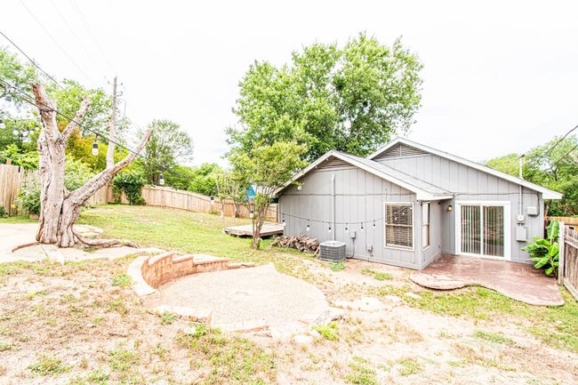 Fenced backyard with a patio | Image 24