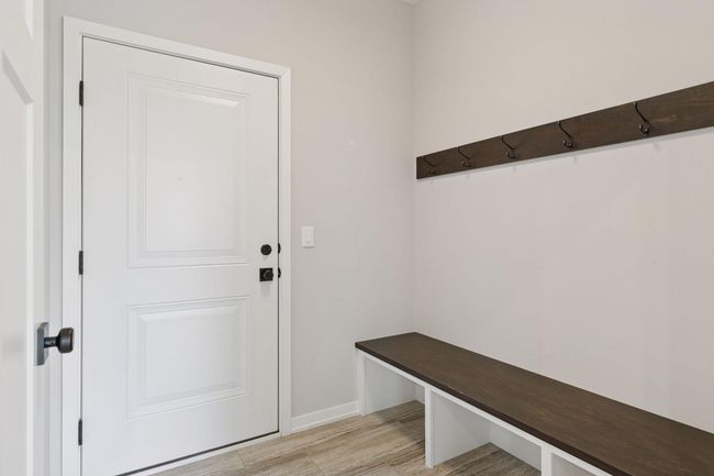 Off the garage is a nice sized mud room complete with custom bench, hooks and a large coat closet | Image 23