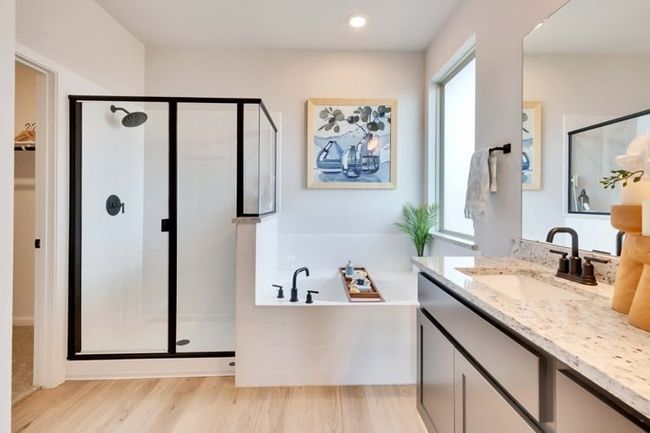 Bathroom with a stall shower, vanity, a bath, wood finished floors, and recessed lighting | Image 9