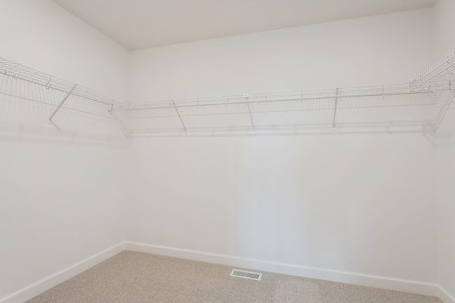 Photo is of the actual home. This primary suite features an incredible walk-in closet. | Image 10