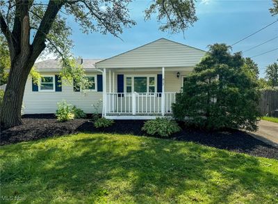 Single story home featuring covered porch and a front yard | Image 1