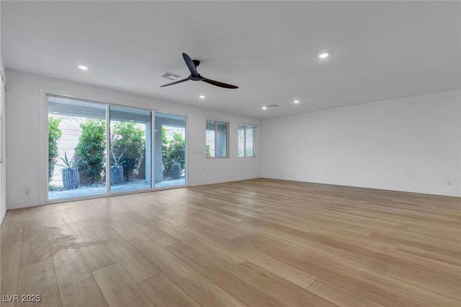 Unfurnished room featuring light wood-style floors, a ceiling fan, recessed lighting, and baseboards | Image 21