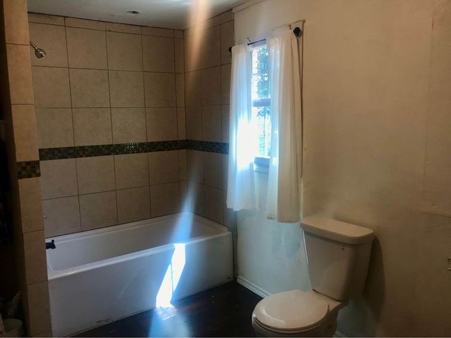 Full bathroom featuring toilet and baseboards | Image 12