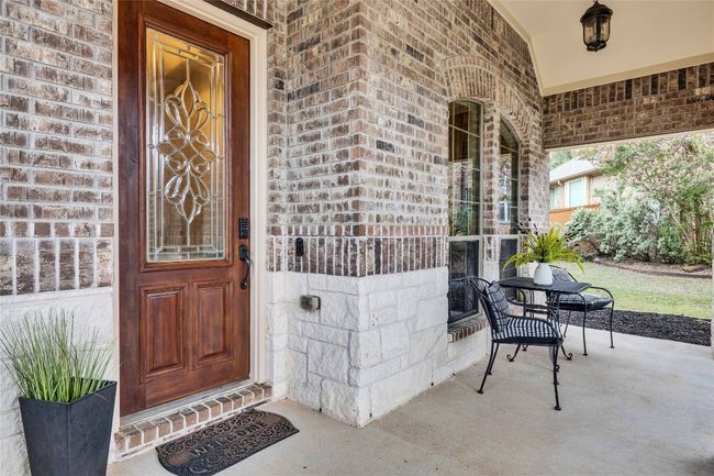 Doorway to property featuring brick siding and a spacious porch | Image 7