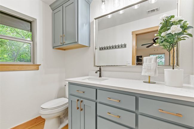 Ensuite Bath Updated with Freshly Painted Cabinets, Quartz Countertops, Lovely Hardware and Decorative Lighting. | Image 14