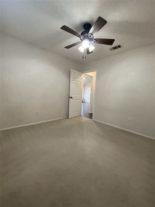 Unfurnished room with a textured ceiling, visible vents, a ceiling fan, and baseboards | Image 22