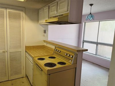 This little kitchen needs a total remodel, and could incorporate the breakfast area to make it multi-cook friendly. | Image 3