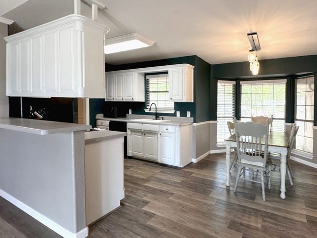 Window over sink in kitchen open to living space | Image 7