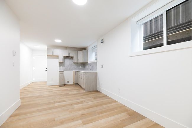 Kitchen featuring tasteful backsplash, light wood-style floors, baseboards, recessed lighting, and a sink | Image 34