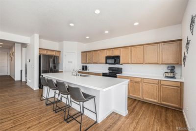 Expansive kitchen with all appliances included, ample storage, and a generous pantry. | Image 3