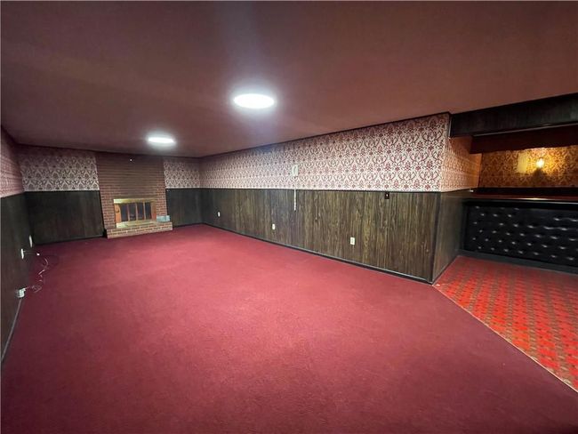 Finished basement with a fireplace, carpet, and recessed lighting | Image 28
