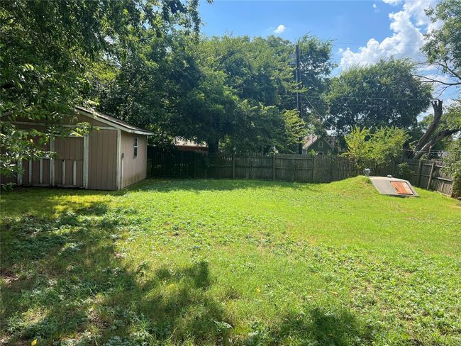 Fenced backyard with an outbuilding | Image 20