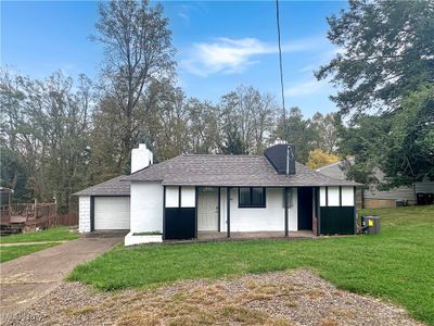 View of front facade with a front yard, a garage, and cooling unit | Image 1