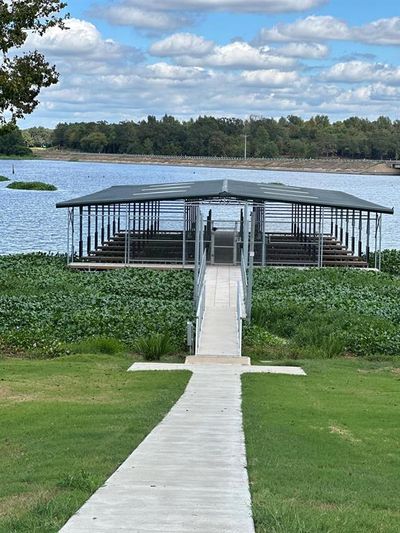 View of dock with a water view and a lawn | Image 3