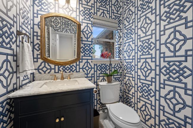 Half bath featuring vanity, wallpapered walls, and tile walls | Image 19