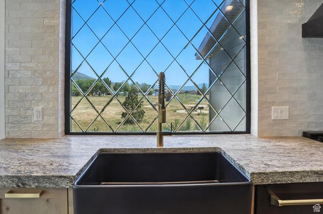 Kitchen view of a sink and backsplash | Image 12