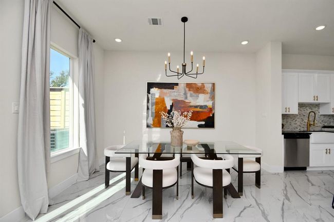 Enjoy entertaining in your dining space which is flooded with natural sunlight. | Image 11