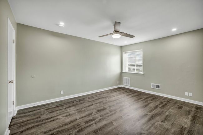 Spare room with dark wood-type flooring, a ceiling fan, baseboards, and recessed lighting | Image 13