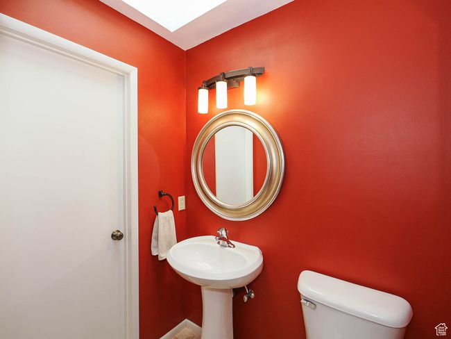 Half bath with toilet Washer & Dryer hook ups inside the closet. | Image 36