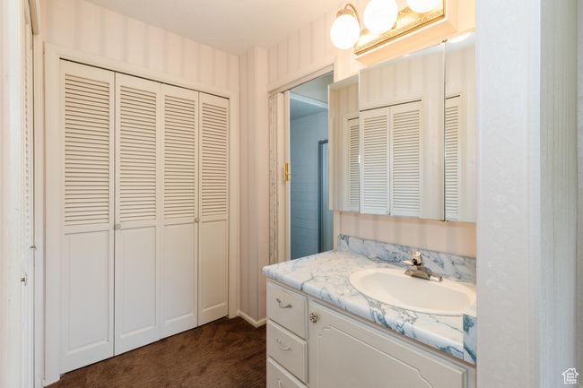 Bathroom featuring a closet and vanity | Image 13