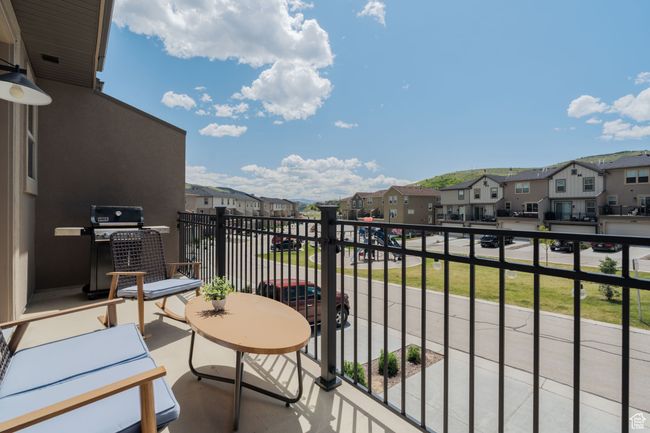 Balcony featuring a residential view and grilling area | Image 20