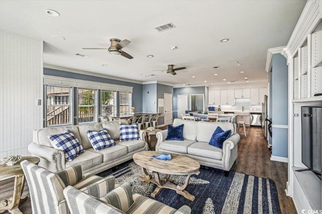 Living room with dark wood-style flooring, recessed lighting, crown molding, and ceiling fan | Image 5