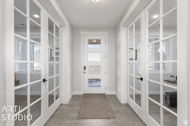 Doorway to outside featuring french doors, baseboards, and wood finished floors | Image 5