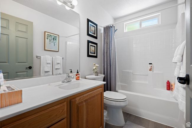 Bathroom with wood finished floors, shower / tub combo with curtain, toilet, and vanity | Image 15