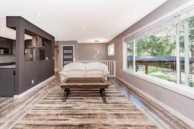 Bedroom with light wood-style floors, baseboards, freestanding refrigerator, and recessed lighting | Image 4