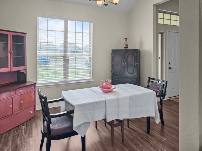 Dining area with plenty of natural light, a chandelier, and dark wood-style floors | Image 11