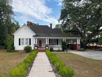 View of front of house featuring a front yard and covered porch | Image 1