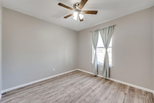 Secondary Bedroom with baseboards, light wood-style flooring, and ceiling fan | Image 17