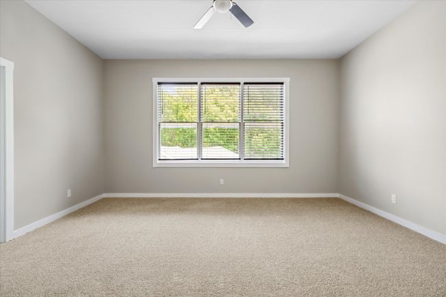 Unfurnished room featuring a ceiling fan, carpet floors, and baseboards | Image 25