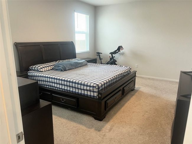 Bedroom with light carpet and baseboards | Image 11