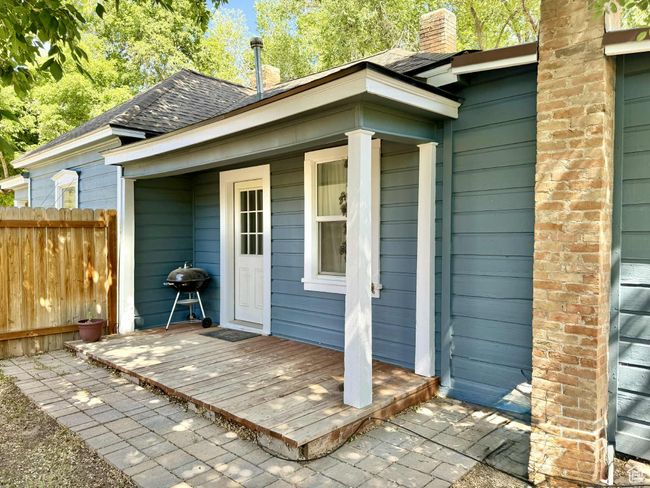 Property entrance featuring a shingled roof and a chimney | Image 13
