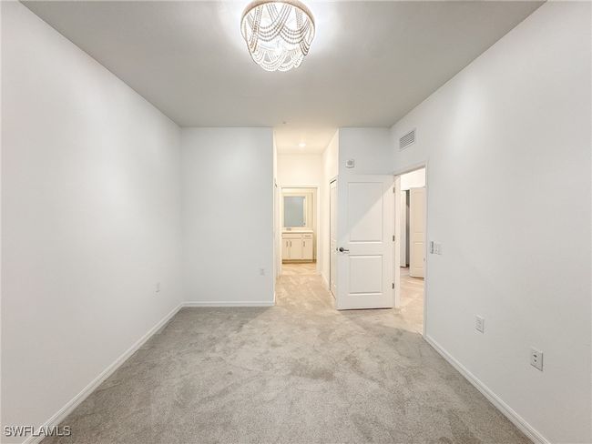 Empty room featuring light colored carpet and baseboards | Image 24