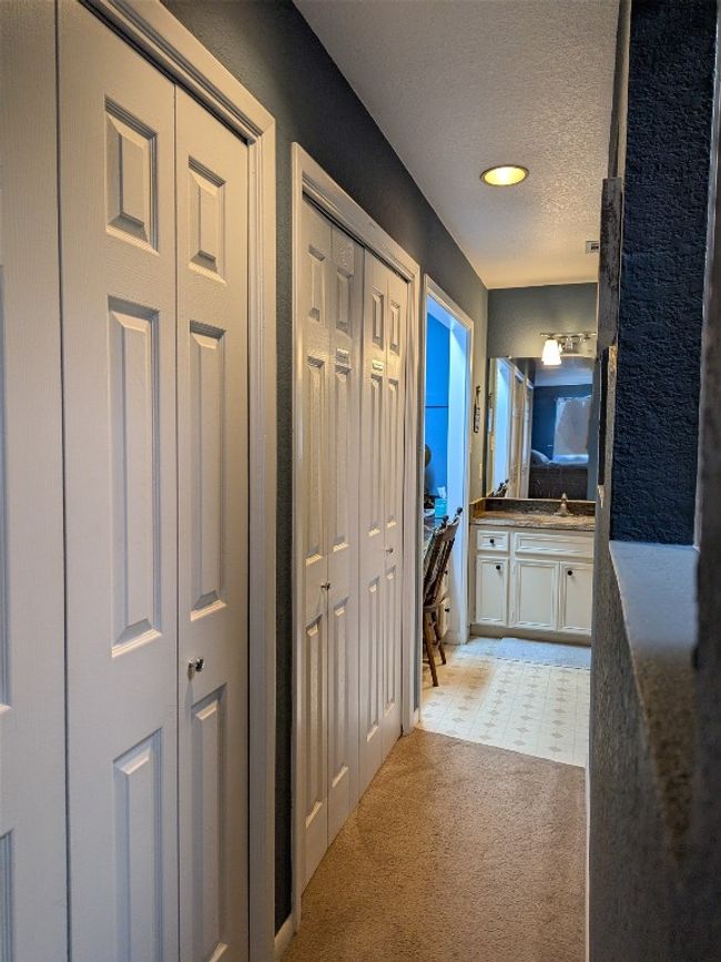 Hall with a textured ceiling and light colored carpet | Image 23