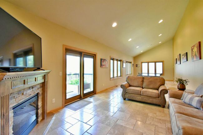 Main floor flex room with fireplace and access to deck | Image 17
