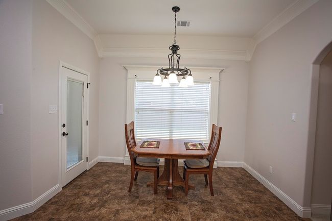 Bedroom featuring light carpet, ceiling fan, and a raised ceiling | Image 8