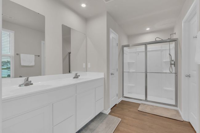 The primary bathroom offers a thoughtfully designed layout, as well as a private toilet room with an upgraded bidet feature, a spacious linen closet for all your storage needs, and an upgraded showerhead for a luxurious touch. | Image 32