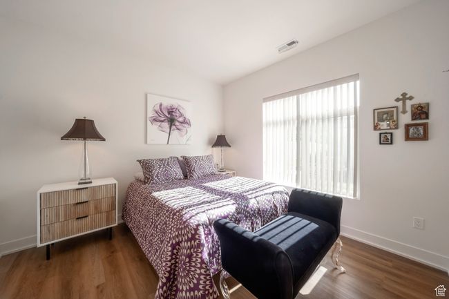Bedroom with wood finished floors and baseboards | Image 6
