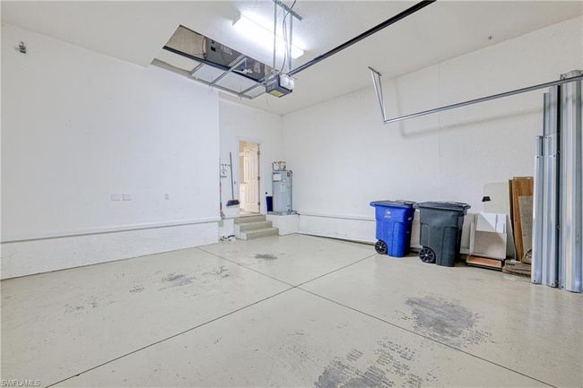 Garage with a garage door opener and electric water heater | Image 12