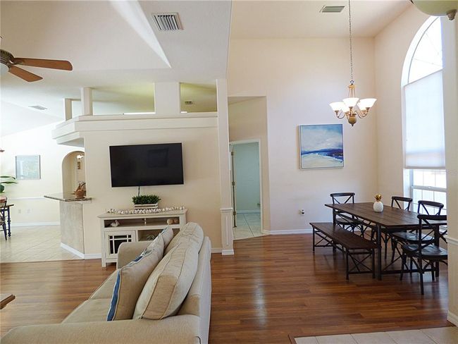 open floor plan with high ceiling, high windows, glass french doors and wide sliding pocket door | Image 11