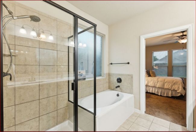 Bathroom with tile patterned floors, connected bathroom, a bath, a shower stall, and a ceiling fan | Image 13