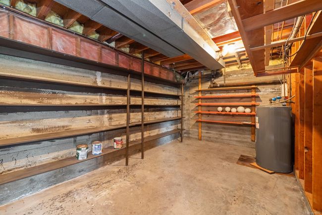 Unfinished basement featuring water heater | Image 29