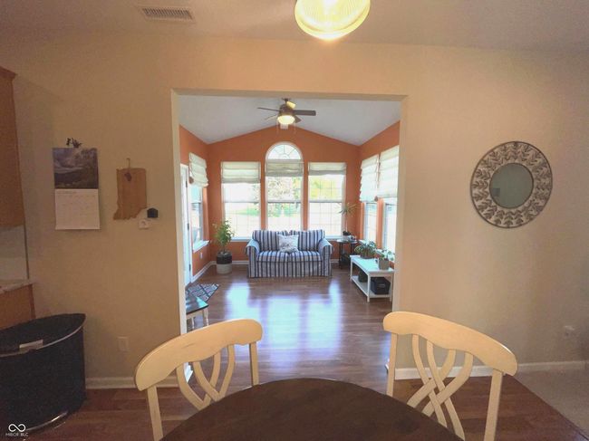 dining room with wood finished floors and a chandelier | Image 7